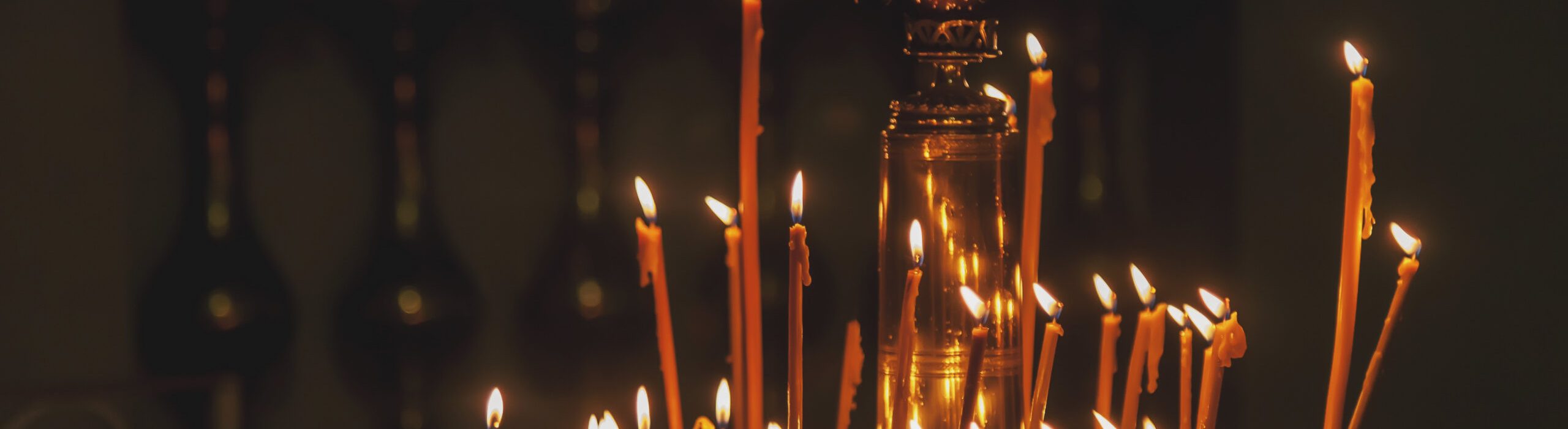 Many burning wax candles in orthodox church or temple for ceremony easter Many burning wax candles in orthodox church or temple for ceremony easter. Background orange candles easter burn in orthodox temples. Concept of church backgrounds for creativity. Copy space for site